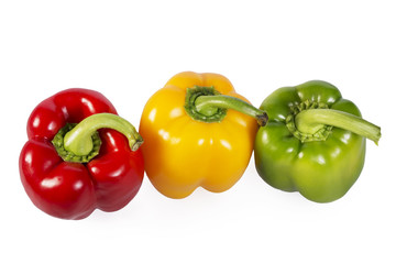 Red, green and yellow paprika on white