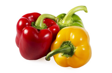 Red, green and yellow paprika on white