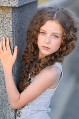 Naklejka premium portrait of little girl outdoors in summer