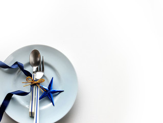 Tableware with white tag price and shiny blue star. Christmas concept.