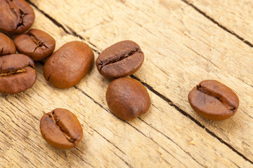 Well roasted coffee beans on old wooden table