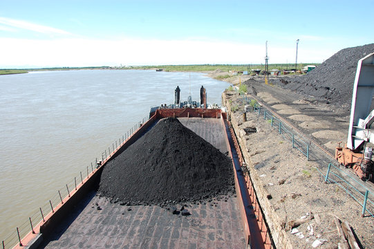 Barge with coal at river port Kolyma