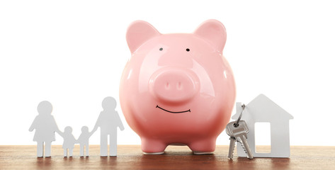 Pig money box and paper decor on a table isolated on white