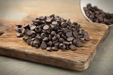Chocolate morsels on wooden board