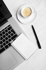 Empty  notebook on laptop keyboard, on light background