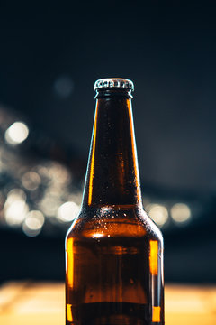 dark bottle of beer on a  blurred background