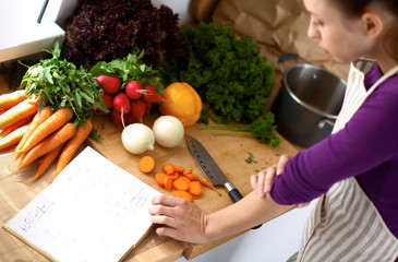 Young woman cutting vegetables in the kitchen