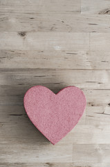 Pink Heart Shaped Box on Wood Plank Table from Above