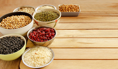 Different kinds of Grains, five grains put on wooden background.