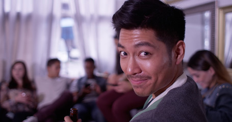 Portrait of Handsome young asian hipster man smiling at party