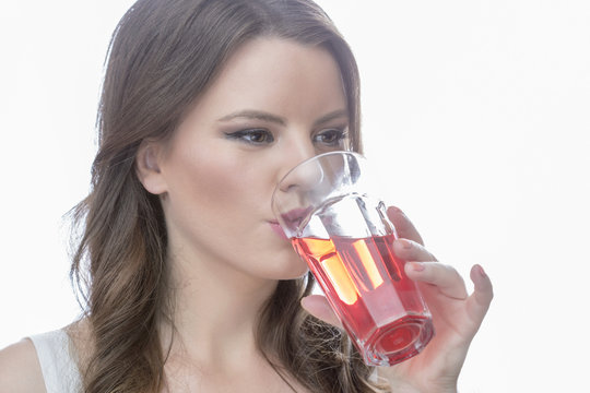 beautiful girl drinking red juice 
