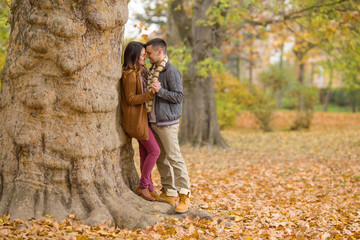 Portrait of a happy young couple enjoying their love in nature on a nice autumn day