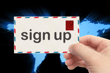 hand holding envelope with sign up word and world background