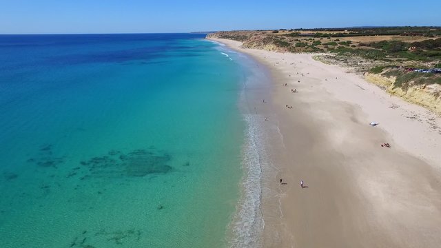 Aerial views of Adelaide Beaches Port Willunga with old shipping jetty & fishermen beach caves near Aldinga Beach in South Australia on Fleurieu Peninsula. Spectacular coastline cliffs and reef. 