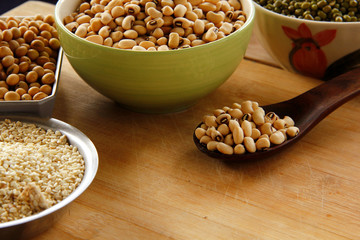 white beens are on wooden background.
