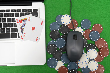 Laptop, poker cards and poker chips