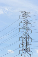 Pylons and cables silhouetted against sky and clouds