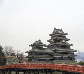 Masumoto Castle , Black palace with red bridge in autumn at naga