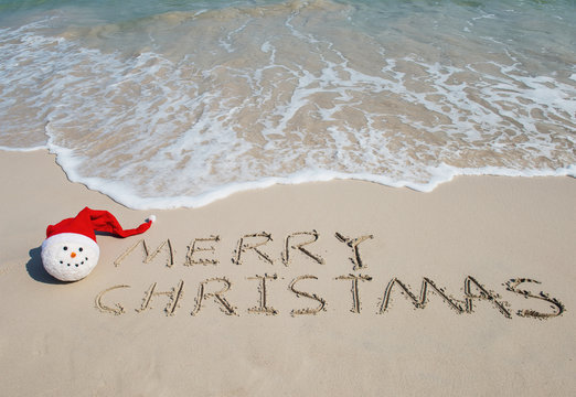Merry Christmas written on tropical beach white sand with xmas s