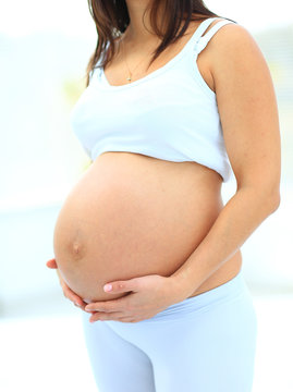 woman holds her baby bump