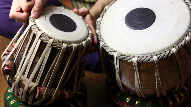 Man tuning on Indian tabla drums 