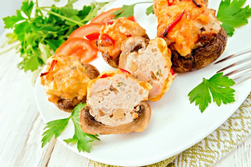 Champignons stuffed meat cut in white plate on board