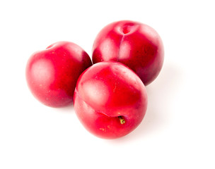 Lustrous natural cherry plums isolated on white