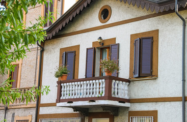 Facade of picturesque building with balcony in the historic cent