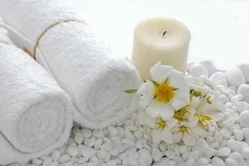 Fototapeta na wymiar gardenia with roller towel ,candle on many stones 