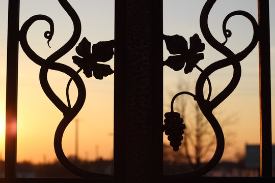 Iron-shod fence in the sunset