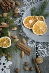Fototapeta na wymiar Christmas still life with delicious, almond, cinnamon, snowflakes on wooden table. Top view.