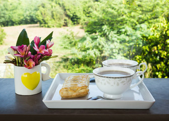 Two cups of hot black coffee with pie on white plate decorated w