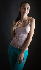 Fototapeta premium Portrait of beautiful sensual woman in T-shirt on a dark background.