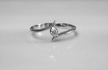 Closeup old diamond ring on blurred marble floor background in black and white tone