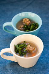 Soup with meatballs and parsley