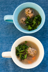 Soup with meatballs and parsley