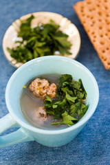 Soup with meatballs and parsley