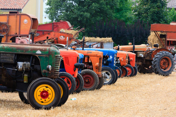 Fototapeta premium Detail of old tractors in perspective, agricultural vehicle, rural life