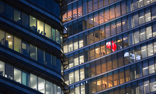 LONDON, UK - 7 SEPTEMBER, 2015: Canary Wharf office's windows lit up at dusk, Business life concept background