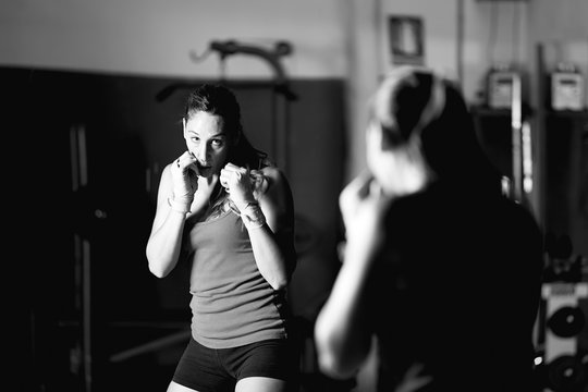Professional female boxer practicing strokes