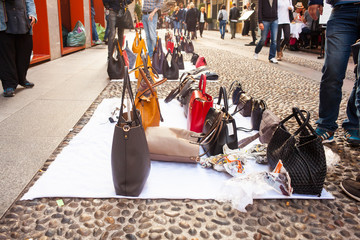 Counterfeit italian bags for sales in the street - obrazy, fototapety, plakaty