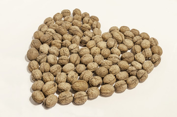 Walnuts heart shaped on white