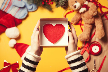Woman wrapping a heart shape toy
