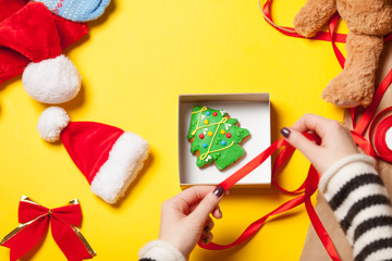 Woman wrapping gingerbread cookie