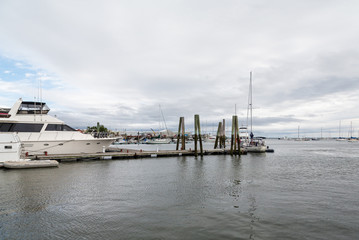 Fototapeta premium White Boats on Wood Pier on Grey Day