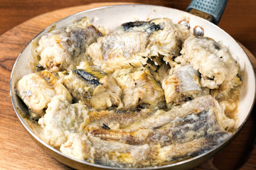 Fried pollock in the pan