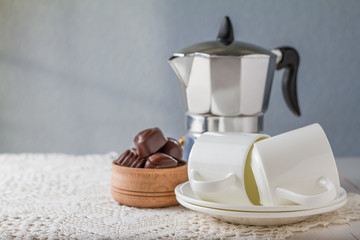 Chocolate candies with coffee and candles