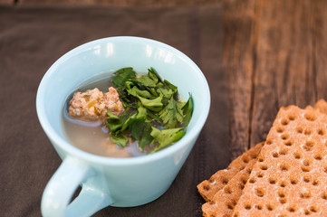 Soup with meatballs and parsley