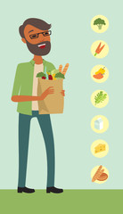  Man holding a shopping bag full of vegetables 