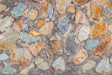 Color stone in the cement wall for background texture.